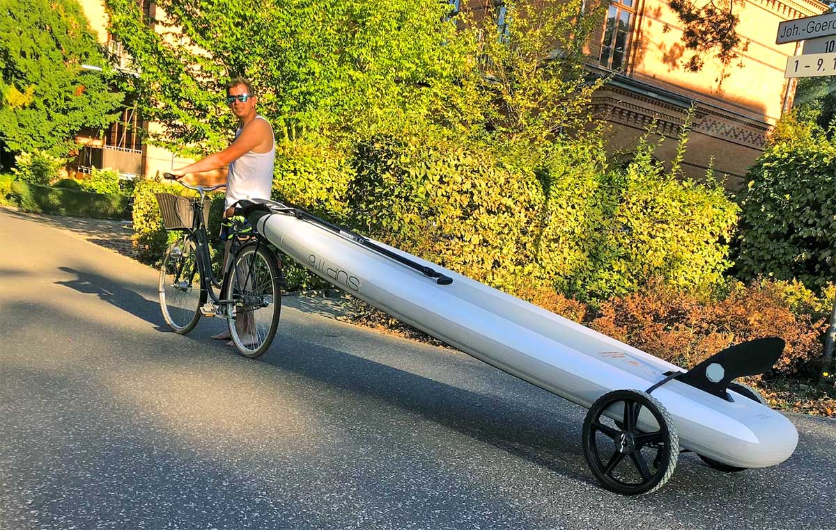 SUP Wheels new product for inflatable paddle boards on a bike with a man